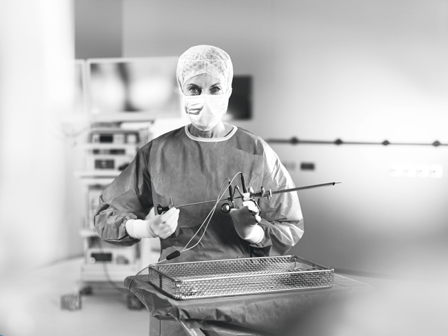 Doctor with resectoscope in operating room.